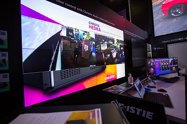 Angled view of a large screen with a desk in front.